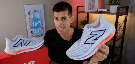 Image of a male holding two types of running shoes