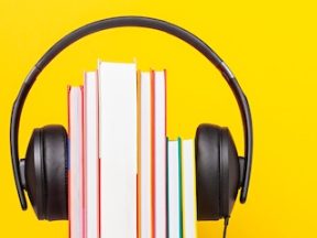 Illustration of headphones on a stack of books